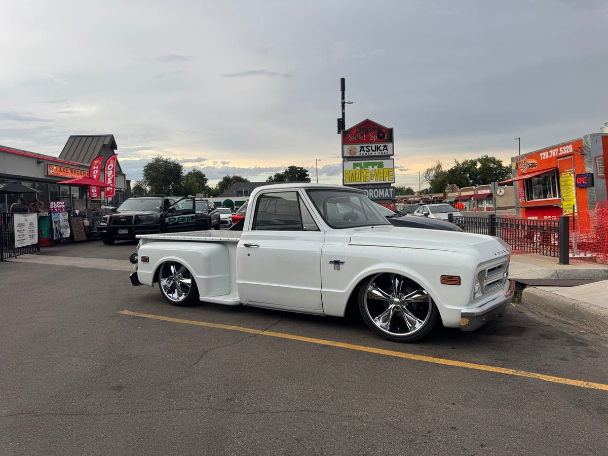 White 1968 Chevrolet C10 Stepside parked outdoors, viewed from the front passenger side.