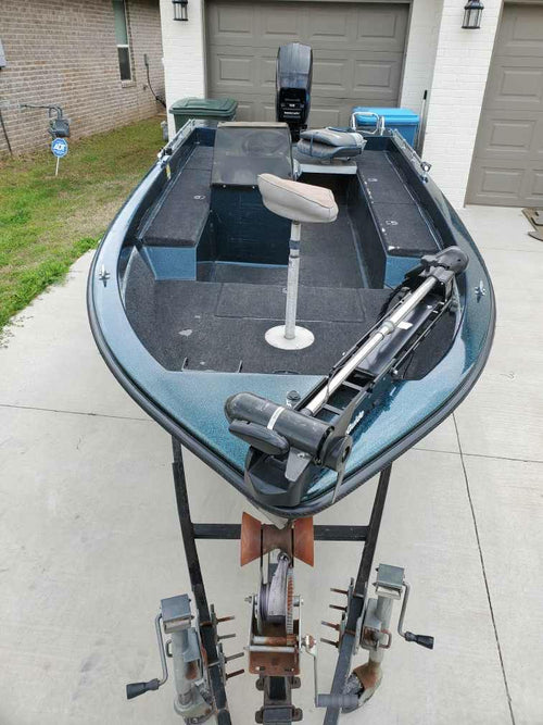 View from the bow of the 1990 Ranger Fisherman showing MotorGuide trolling motor, raised fishing seat, carpeted deck and center console.