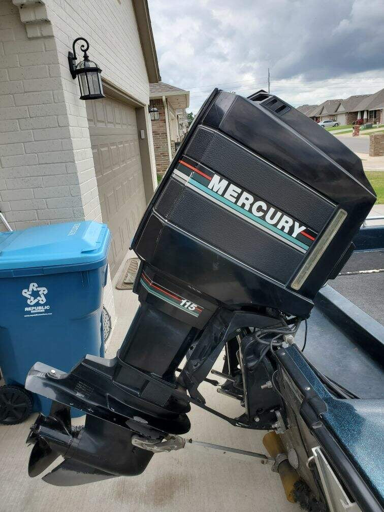 Close-up of the Mercury 115 HP outboard motor mounted on the 1990 Ranger Fisherman.