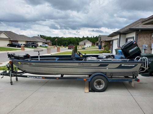 1990 Ranger Fisherman fishing boat with Mercury 115 HP outboard, shown on a Ranger Trail trailer.