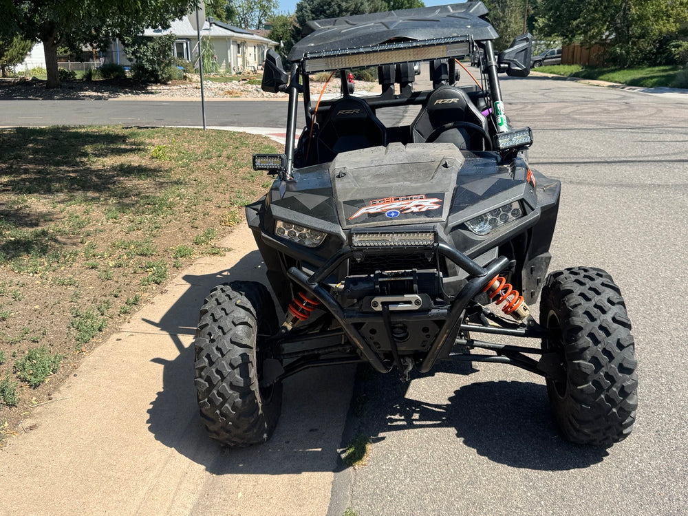 Front view of the 2018 Polaris RZR XP 1000 High Lifter showing LED light bars, auxiliary lights and front winch.
