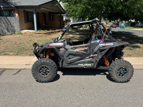 2018 Polaris RZR XP 1000 High Lifter side profile showing wheels, tires, doors and roof.